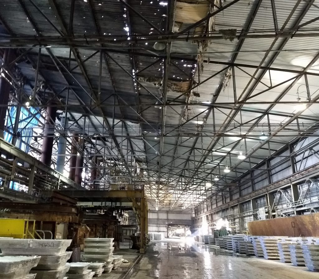 Large Metal Manufacturing Facility with Holes in Roof