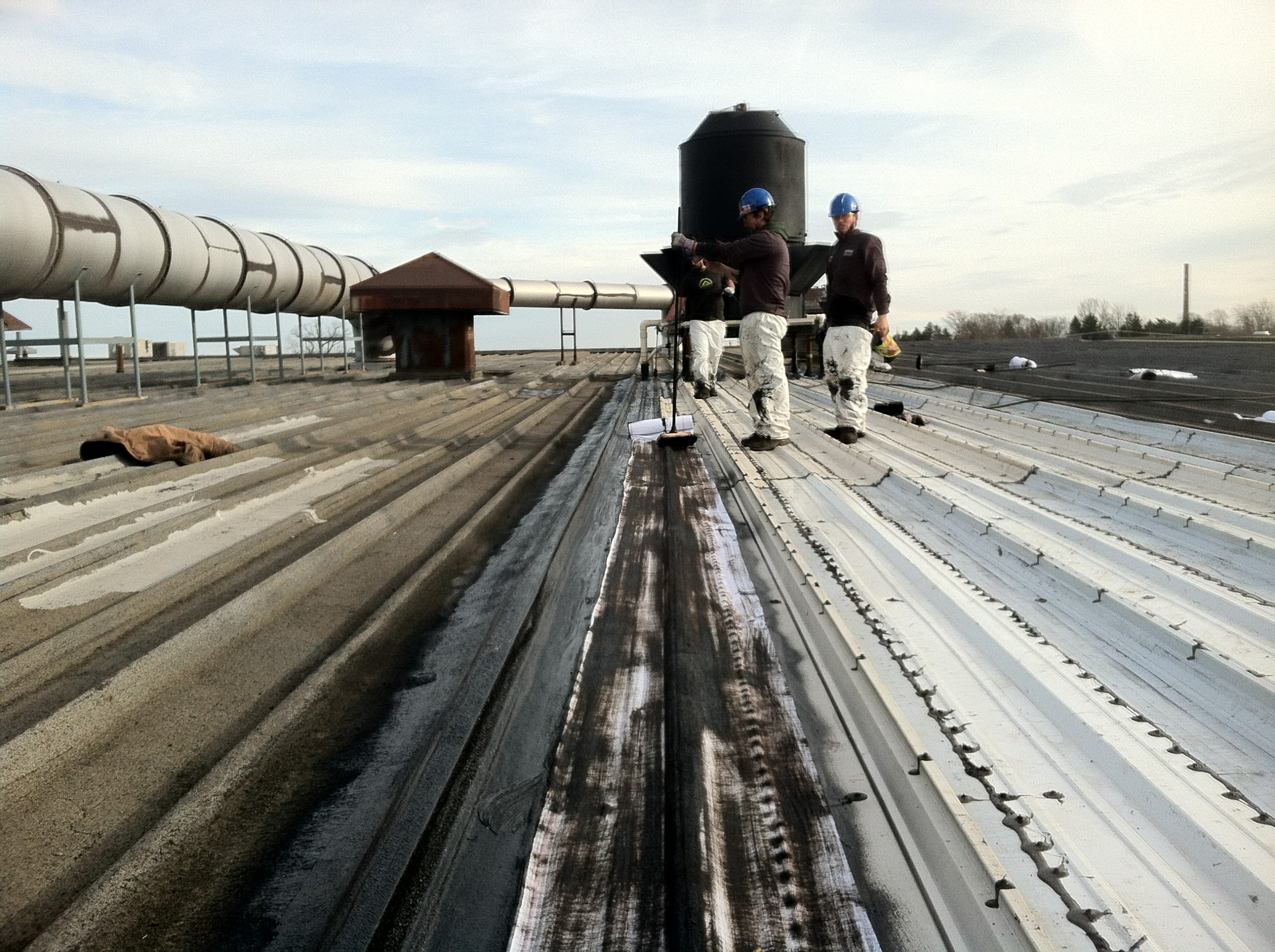 Application of first asphalt coat Application of first asphalt coat