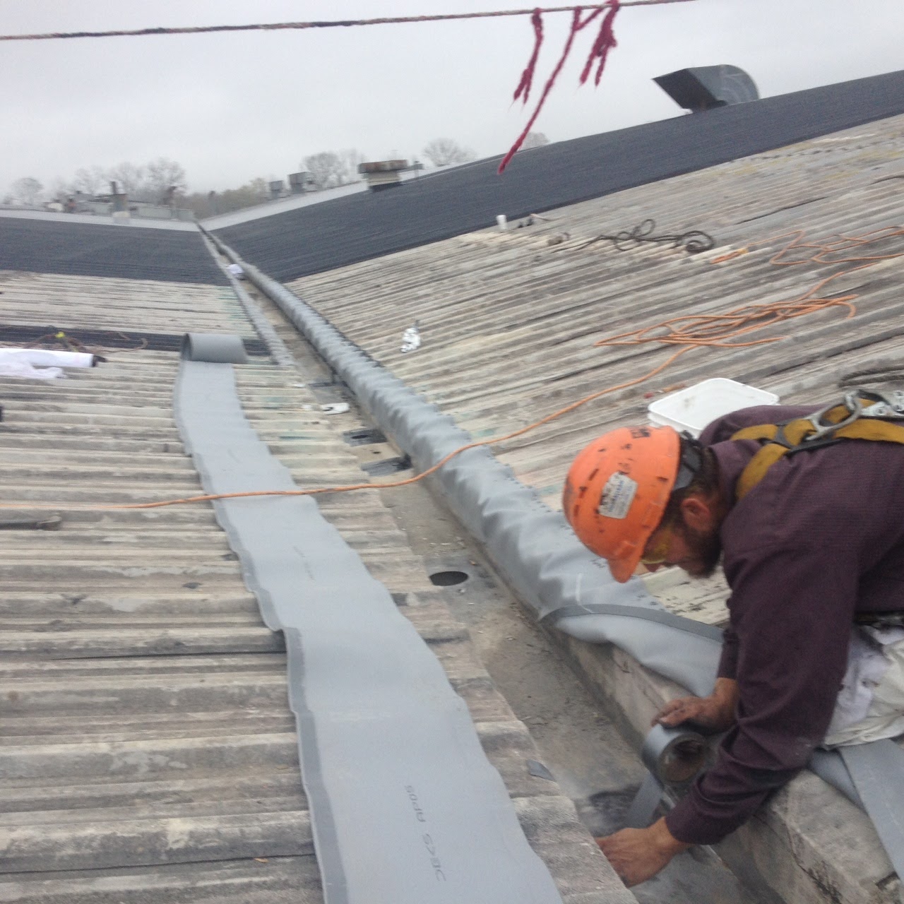 Commercial Roofer Repairing Internal Gutters