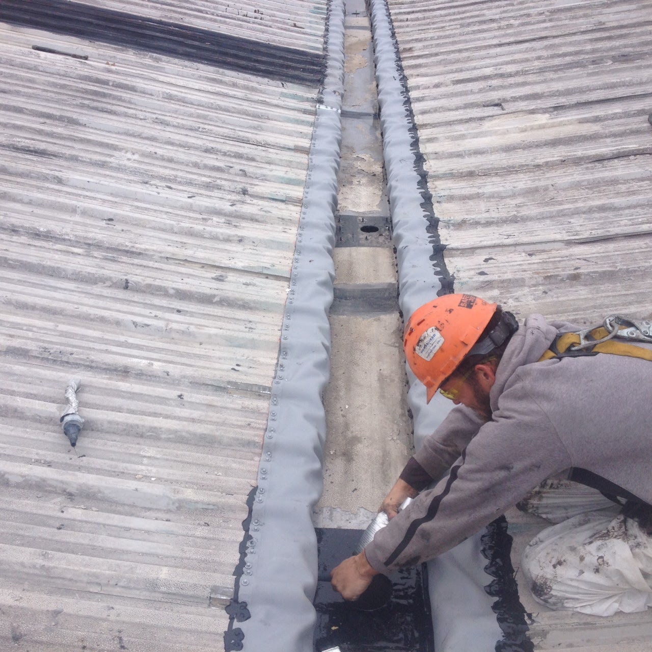 Commercial Roofer Repairing Internal Gutters Commercial Roofer Repairing Internal Gutters