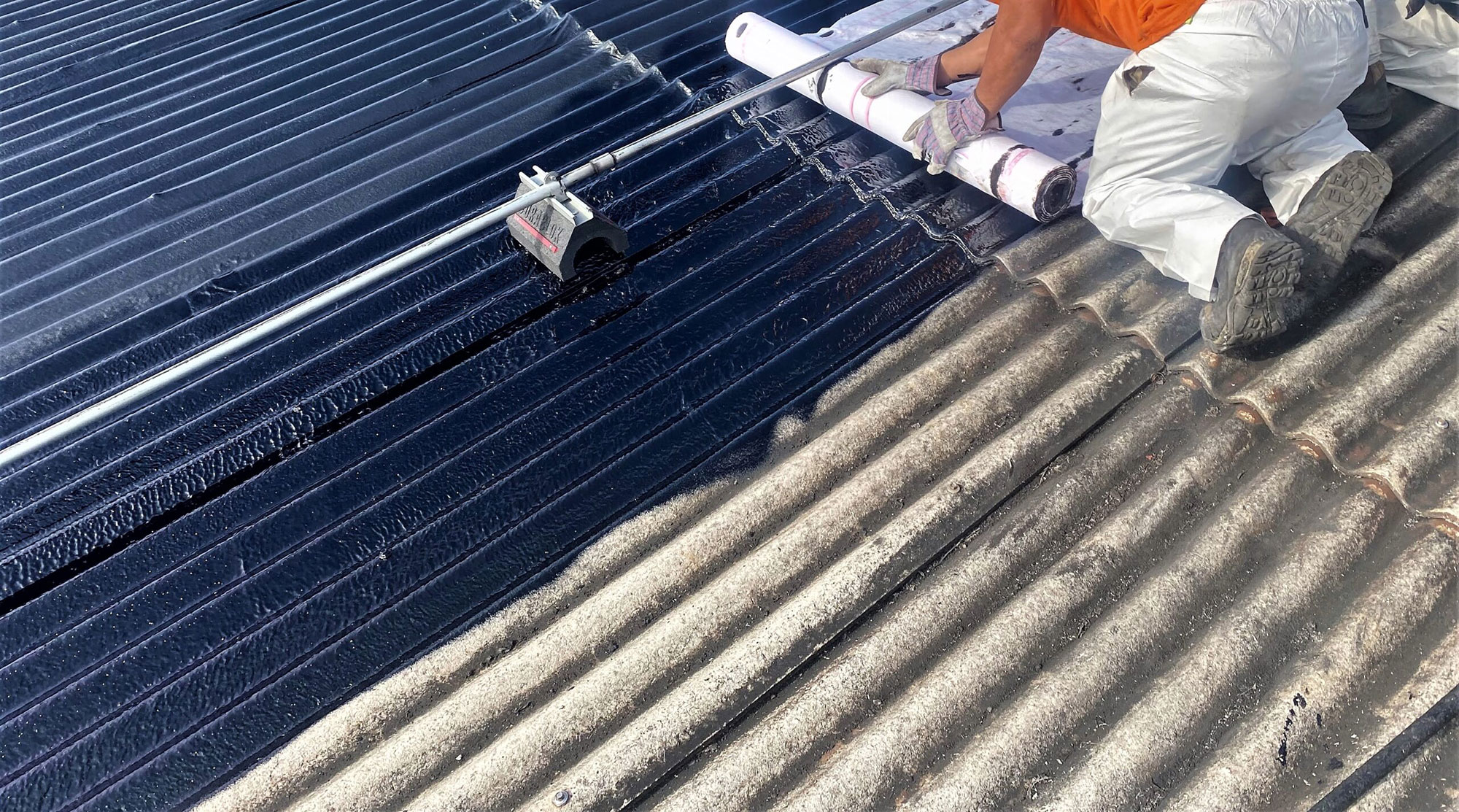 Transite roof repair A commercial roofing crew repairing a Transite asbestos roof