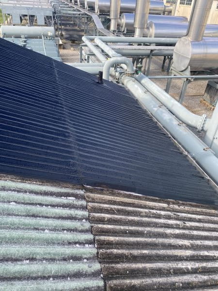 Split view of degraded transite roof and restored roof system on LNG compressor station