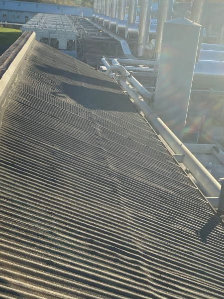 Completed roof restoration system on LNG compressor station transite roof