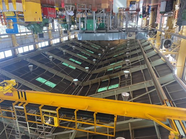 Interior of LNG compressor station with transite roof panels showing industrial infrastructure